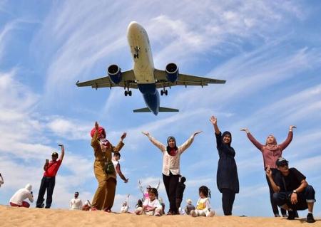 عکس گرفتن گردشگران جزیره تفریحی پوکت تایلند زیر یک هواپیمای در حال فرود در فرودگاه بین المللی پوکت/ گتی ایمجز عکسهای جالب,عکسهای جذاب, گردشگران جزیره تفریحی